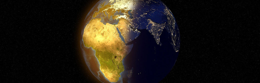 Image of a globe with Africa in daylight and Asia in night on a black background